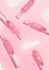 Pink dental floss containers on a pink background