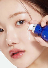 Person applying a blue skincare product to their face