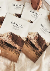 Skincare packaging with desert landscape design and 'Madagascan Centella' text.