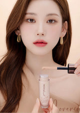 Woman holding a cosmetic bottle and applicator with a soft focus background