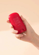 Hand holding a red 'Cellu Light Stick' product against a beige background