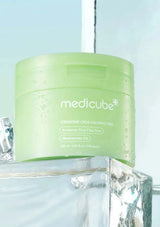 Green jar of Medicube Exosome Cica Calming Pad on a light blue background