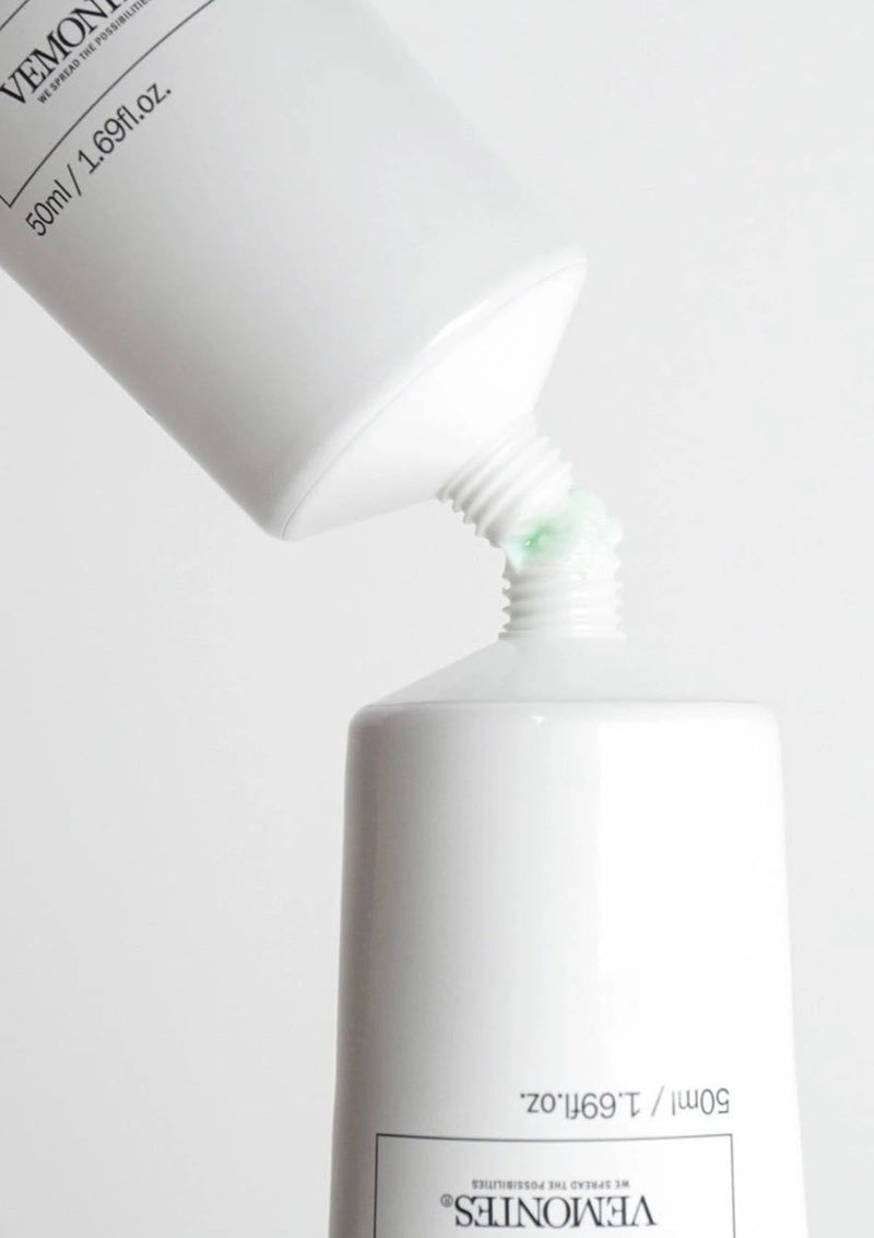 White bottle with a pump dispenser on a white background
