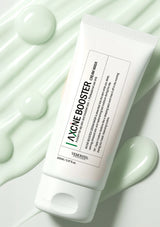 Vemenita Acne Booster Cream Mask tube on a green textured background