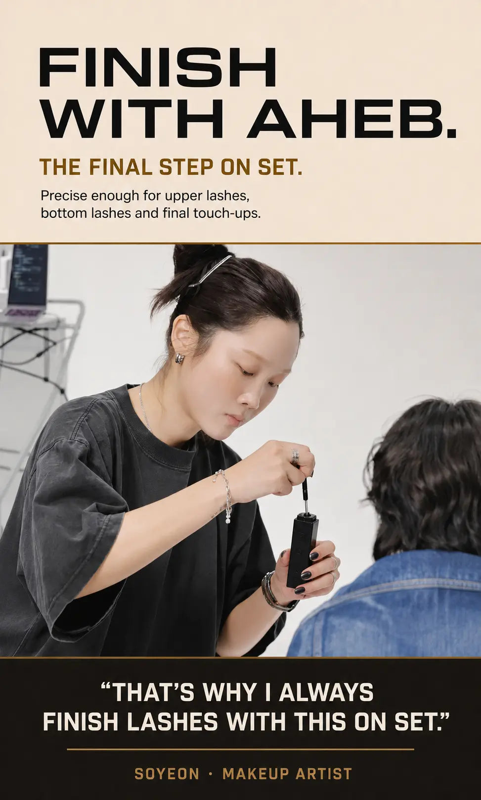 Professional makeup artist finishing upper and lower lashes with AHEB