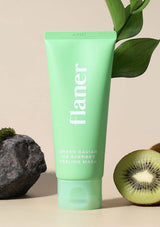 Green skincare product tube labeled 'flaner' with a kiwi fruit and leaves on a beige background
