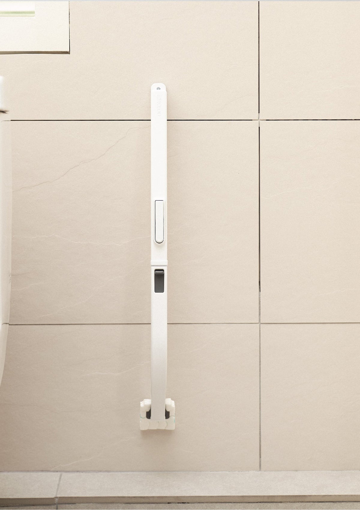 White kitchen cabinet handle on a beige cabinet