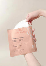 Person holding a hydrogel collagen mask with Nuborn Cellus branding against a neutral background