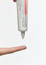 Tube of Derma Zinc Matcha MX Active Cream being squeezed onto a finger against a white background