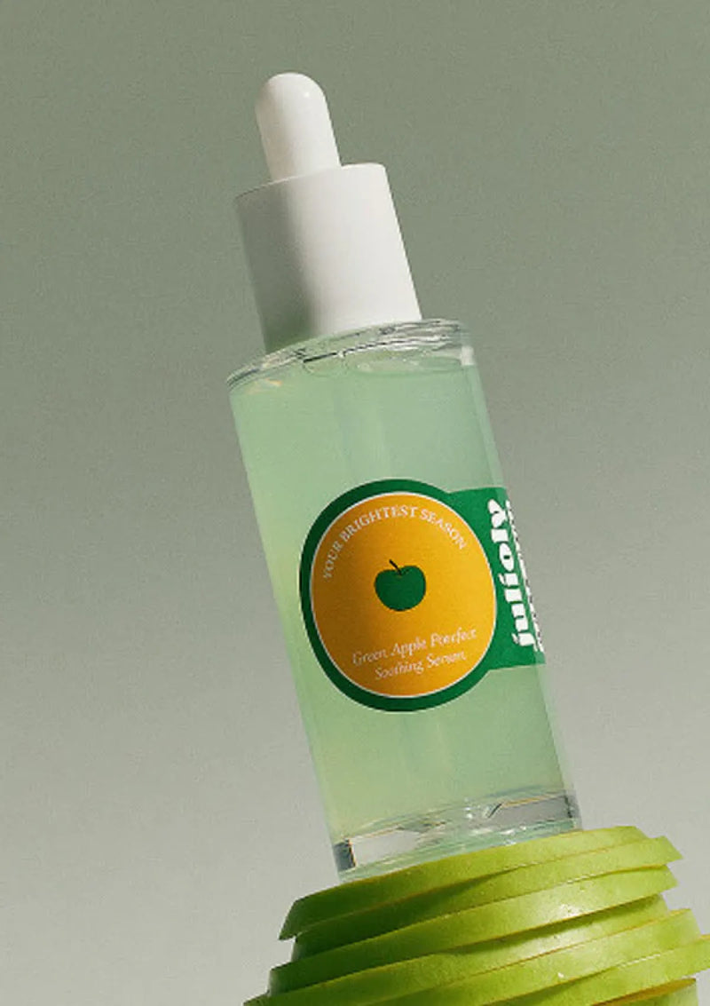 Skincare serum bottle with green label featuring an apple on a gray background