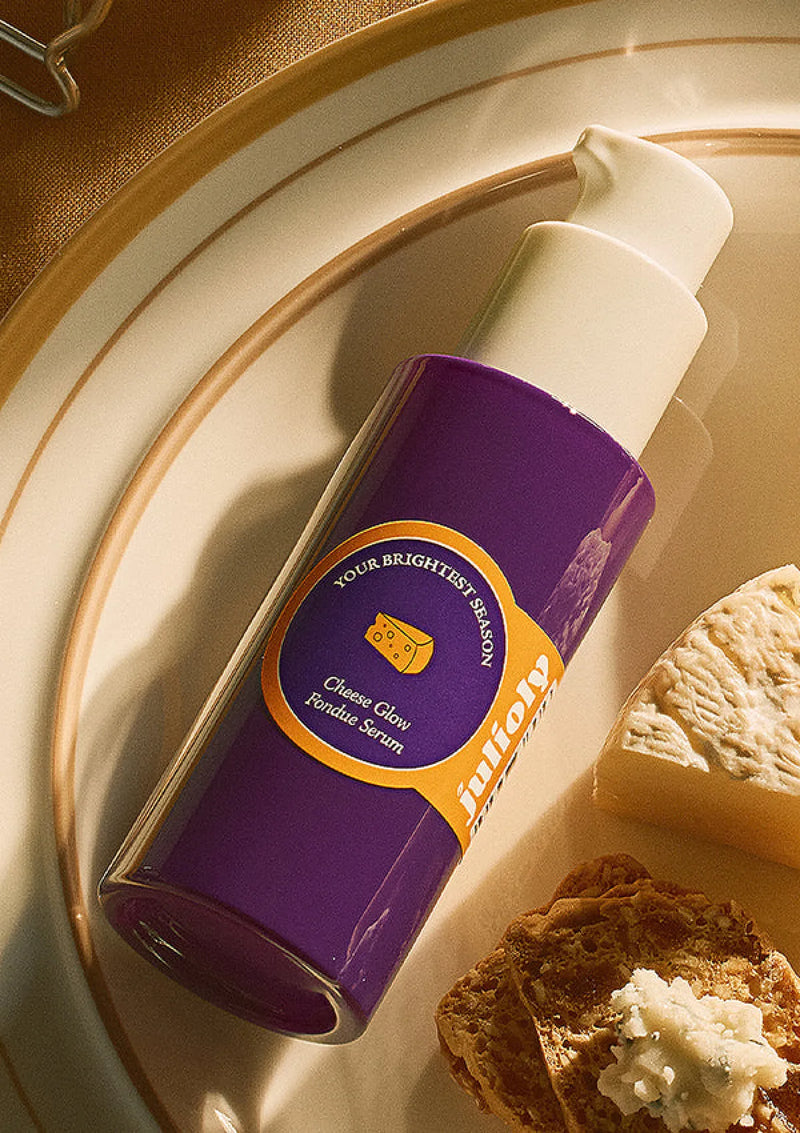 Purple bottle with a yellow label on a plate with bread and butter