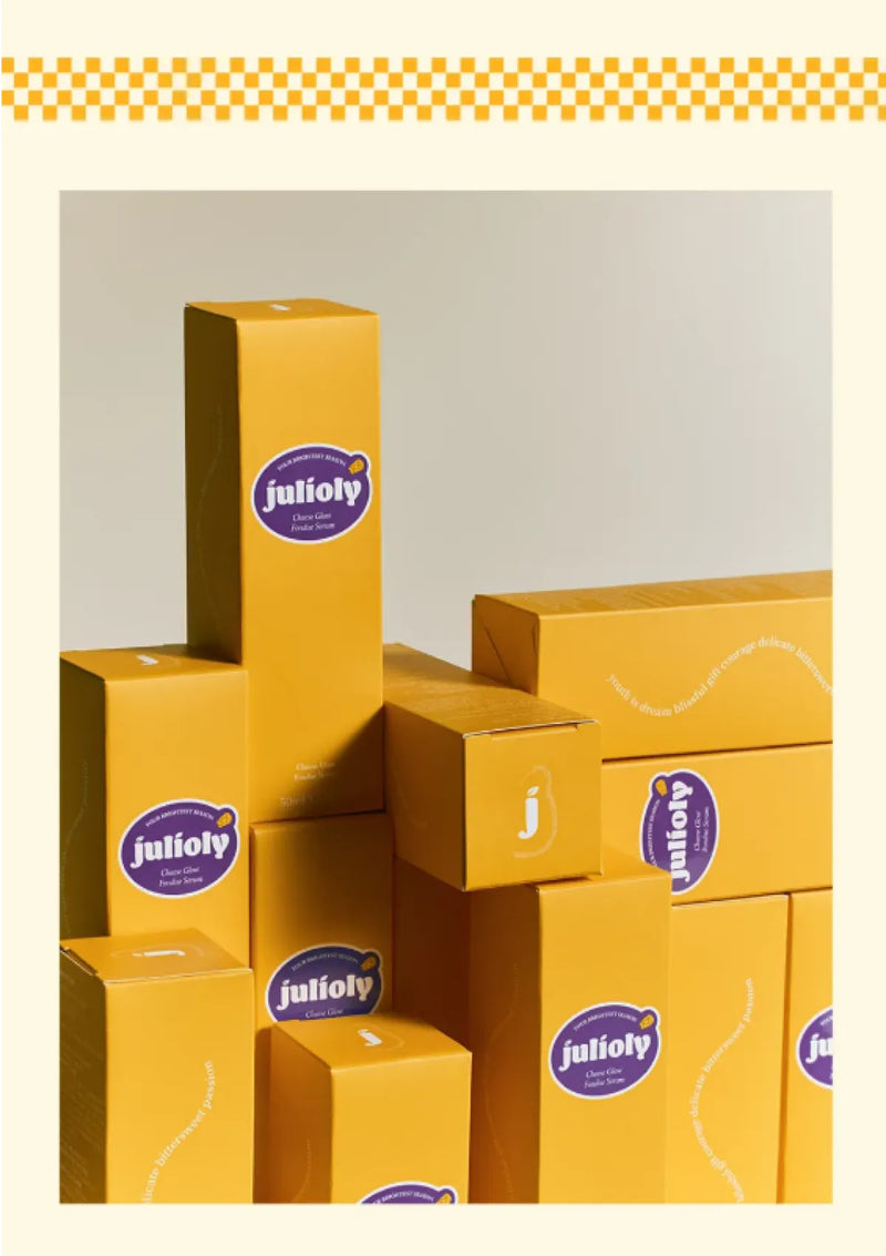 Stack of yellow boxes with Juliofy logo on a light gray background