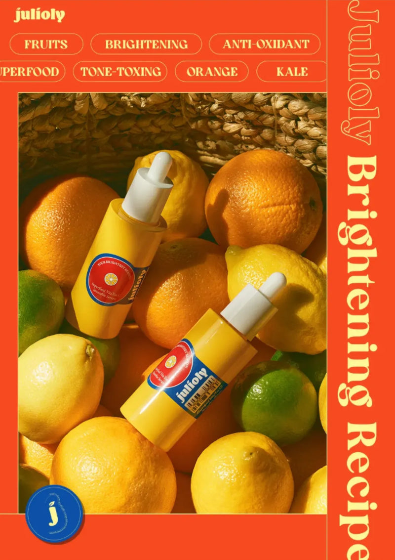 Two yellow skincare bottles with droppers on a background of oranges and limes, branded 'julily'.