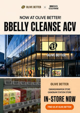 Promotional graphic for BBelly Cleanse ACV at Olive Better stores, featuring a storefront photo, product boxes on a shelf, and text advertising in-store availability.