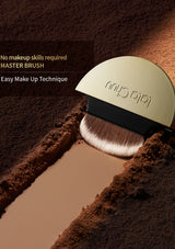 A close-up promotional shot of a LaloChuu makeup brush resting in a trench of brown powder, with text reading 'No special skills required MASTER BRUSH Easy Hair Touch-Up Technique.' The brush has a gold-toned cap, a black handle, and light beige bristles.