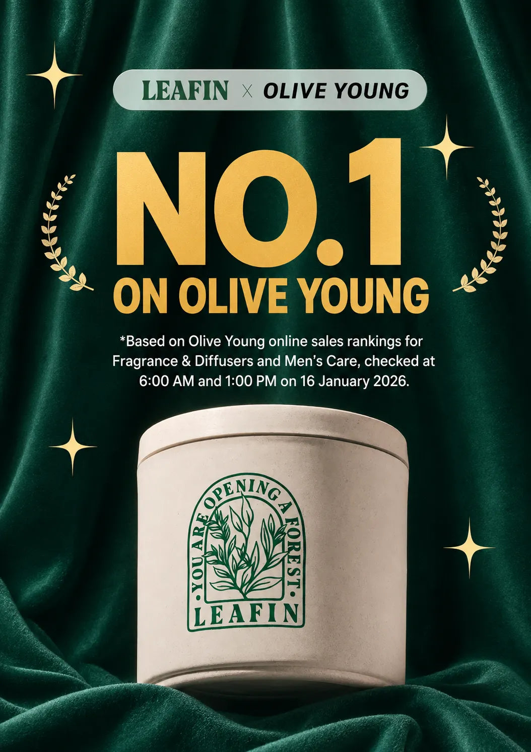 A promotional graphic for a LEAFIN x OLIVE YOUNG fragrance product. A cream-colored cylindrical tin with a green LEAFIN logo sits on draped dark green fabric, surrounded by gold starbursts and laurel wreaths.