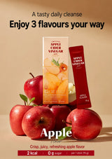 Apple Cider Vinegar product packaging and a single-serve stick pack arranged with fresh red apples on a warm beige background. Text at the top reads 'A tasty daily cleanse Enjoy 3 flavours your way' and 'Apple' appears at the bottom.