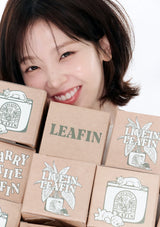 Woman with a stack of LEAFIN boxes on a white background