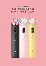 Three MEDICUBE AGE-R BOOSTER PRO devices in black, pink, and yellow on a pink background.