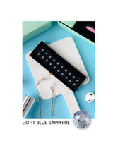 Light blue sapphire stone on a white stand with a blue background