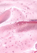 Close-up of pink slime with bubbles and a knife blade.
