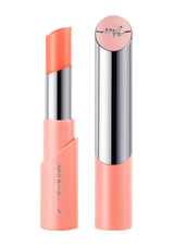 Makeup stick with coral casing and silver cap on a white background