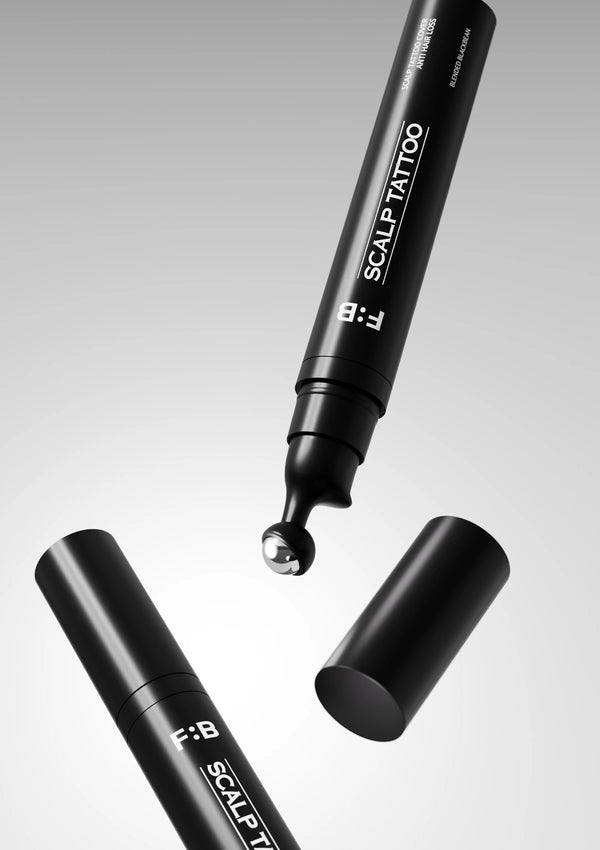 Black scalp tattoo pen with cap on a gray background