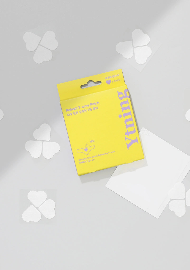 Yellow package with white clover-shaped items on a light gray background