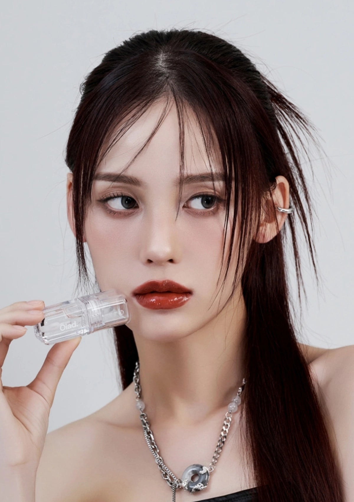 Woman holding a clear bottle with a white background