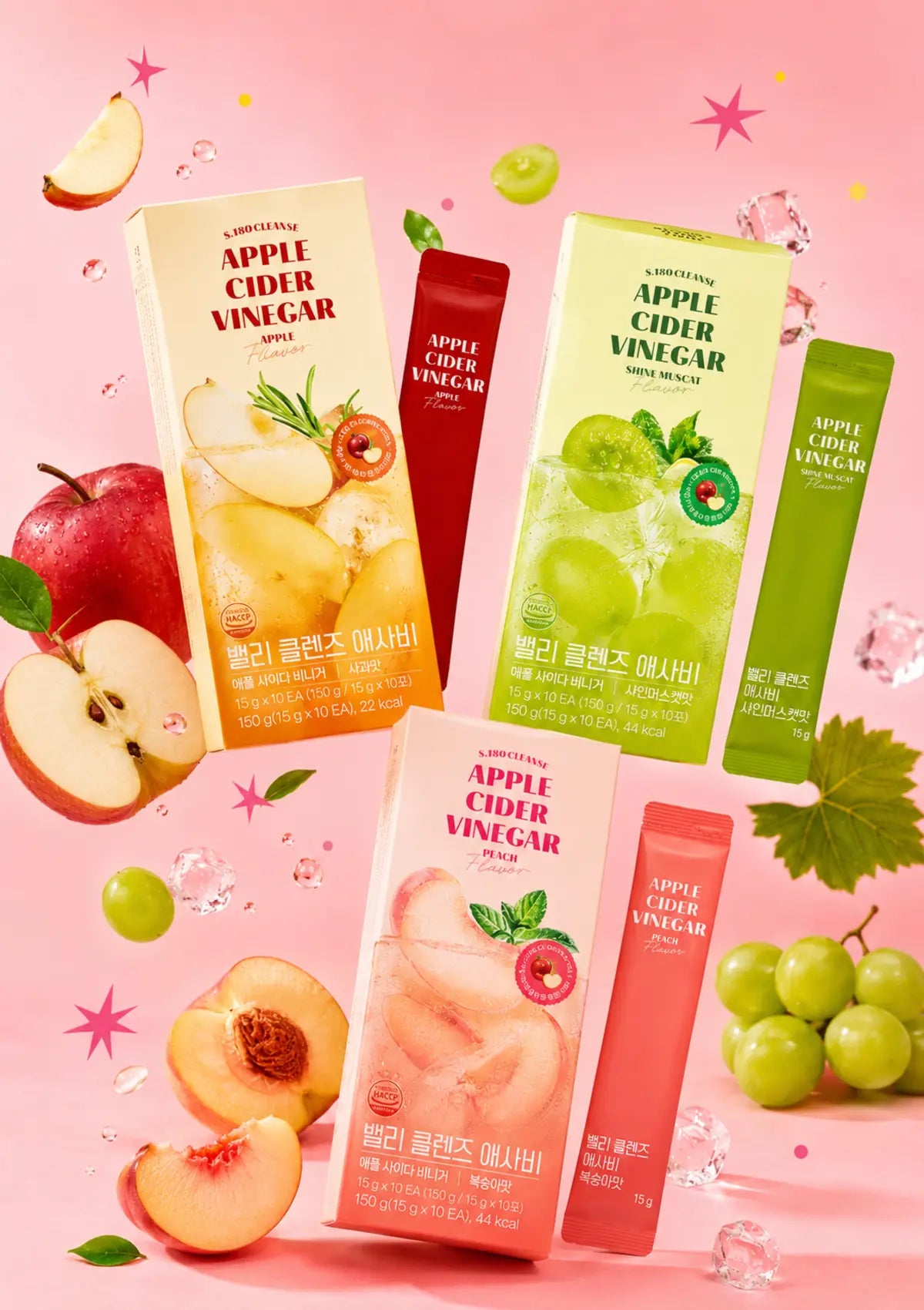 ShakeBaby BBelly Cleanse Apple Cider Vinegar Apple, Peach and Shine Muscat boxes with matching sachets and fresh fruit on a pink background.
