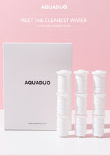 Aquaduo water filter packaging with three white filters on a pink background