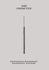 A single slim metallic lash styling tool is centered on a plain light gray background, with the text 'AHEB CHROME STICK' above it and hashtag-style labels below.