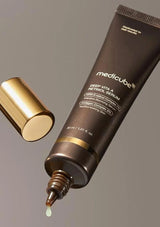 Medicube Deep Vita A Retinol Serum tube with dropper on a gray background