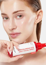Woman holding a bottle of hypochlorous acid daily facial spray with a white background