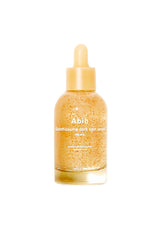 Aibib Shubthopsone Dark Spot Serum in a clear glass dropper bottle filled with a golden-yellow serum and suspended gold glitter, set against a plain white background.