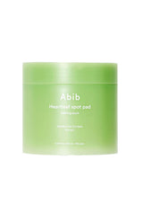 A light green jar of Abib Heartleaf spot pad on a solid white background.